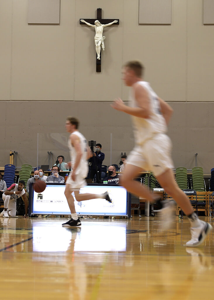 Justin Boyer runs the ball down the court